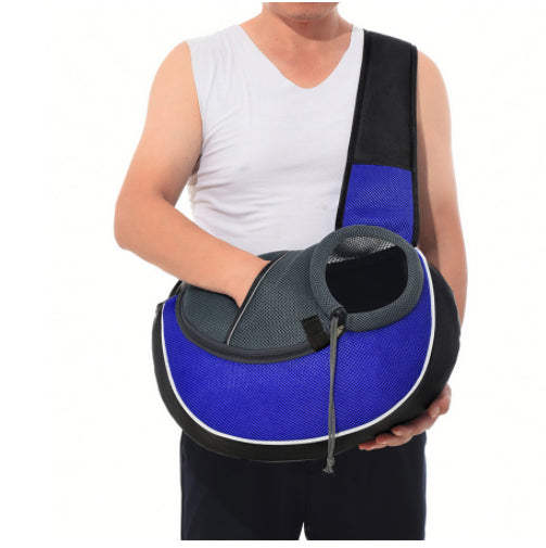 Man holding a Pet Carrier Bag for dogs and cats in blue, designed for easy crossbody carrying.